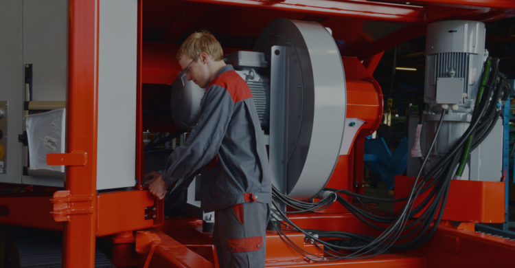 Recycling service technician working on recycling machine